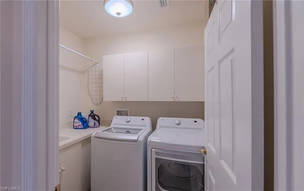 a view of storage and utility room with washer and dryer