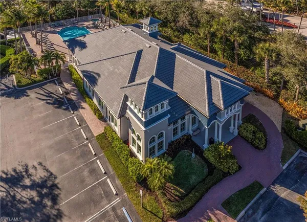 a view of a house with a yard and potted plants