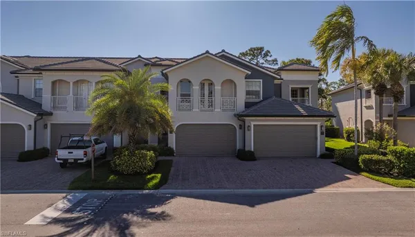 a front view of a house with a garden and plants