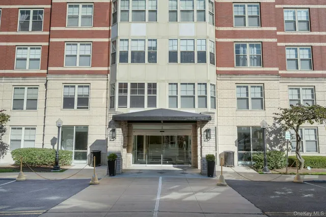 a front view of a building with a garden