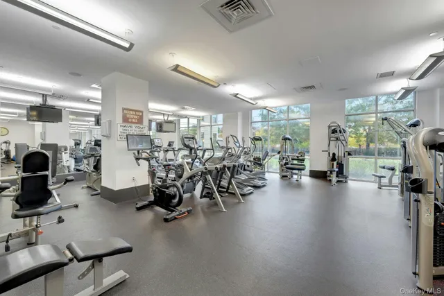 a view of a livingroom with workspace and a window