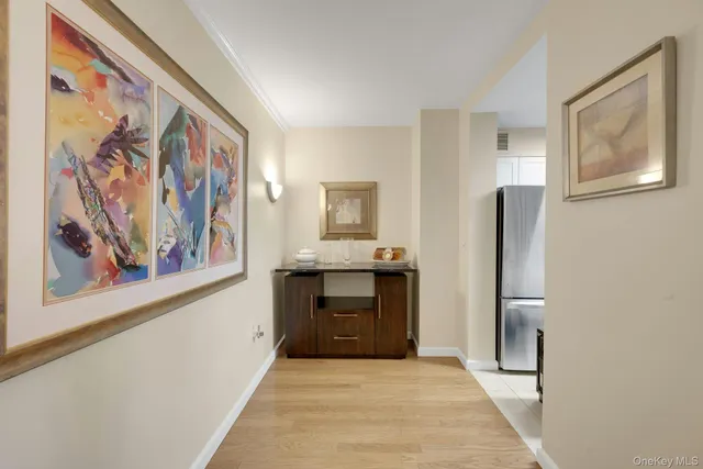 a large kitchen with granite countertop a sink and dishwasher a stove top oven with wooden floor