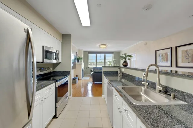 a view of a room with gym equipment and a view of living room