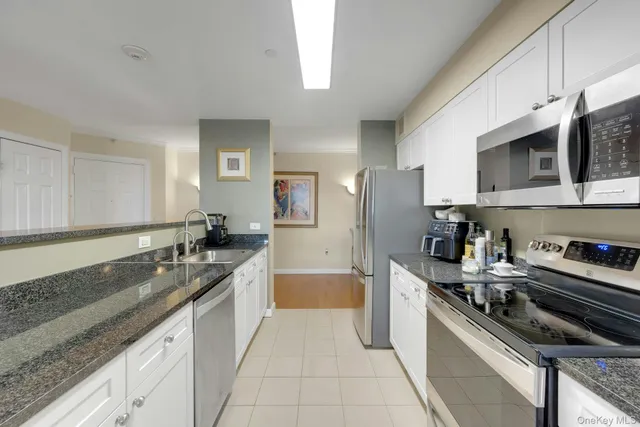a large kitchen with a large counter top appliances and cabinets