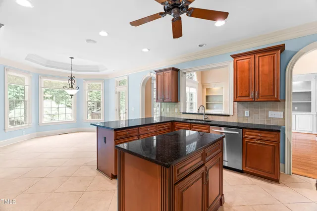 a view of a livingroom with a ceiling fan and window