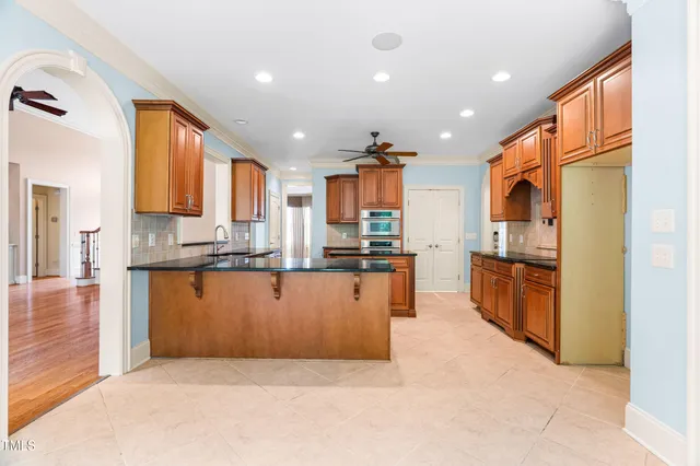 a bathroom with a tub a sink and a large mirror