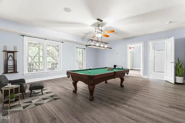 an aerial view of residential houses with outdoor space and trees