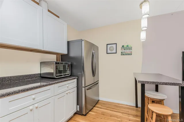 a kitchen with stainless steel appliances granite countertop a refrigerator and a stove top oven