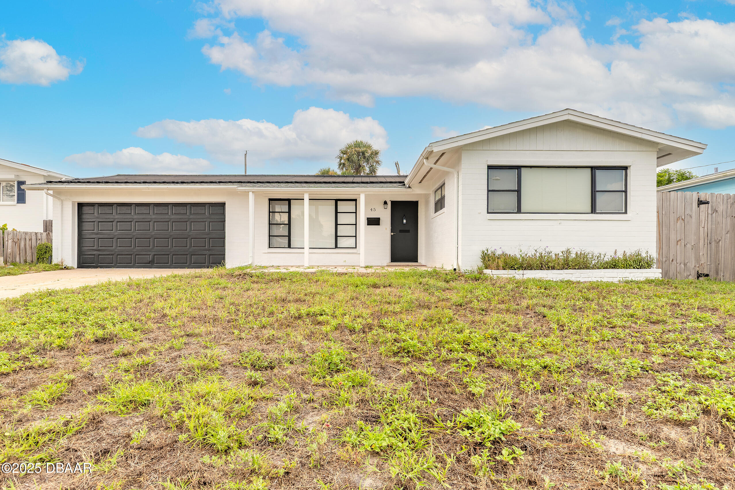 45 Rivocean Drive Ormond Beach, FL 32176 - Photo 1 of 37 a front view of a house with a garden