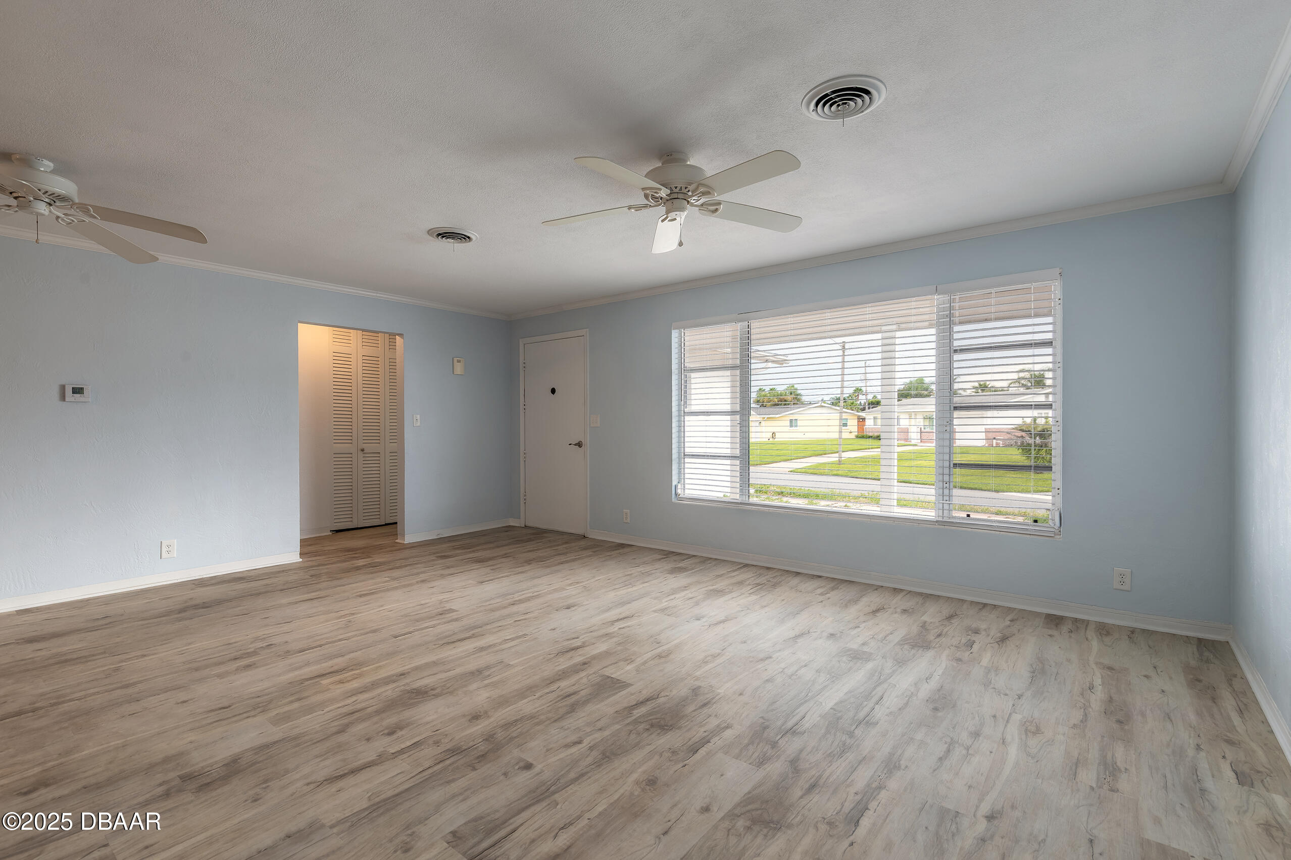 45 Rivocean Drive Ormond Beach, FL 32176 - Photo 12 of 37 a view of an empty room with a window and wooden floor