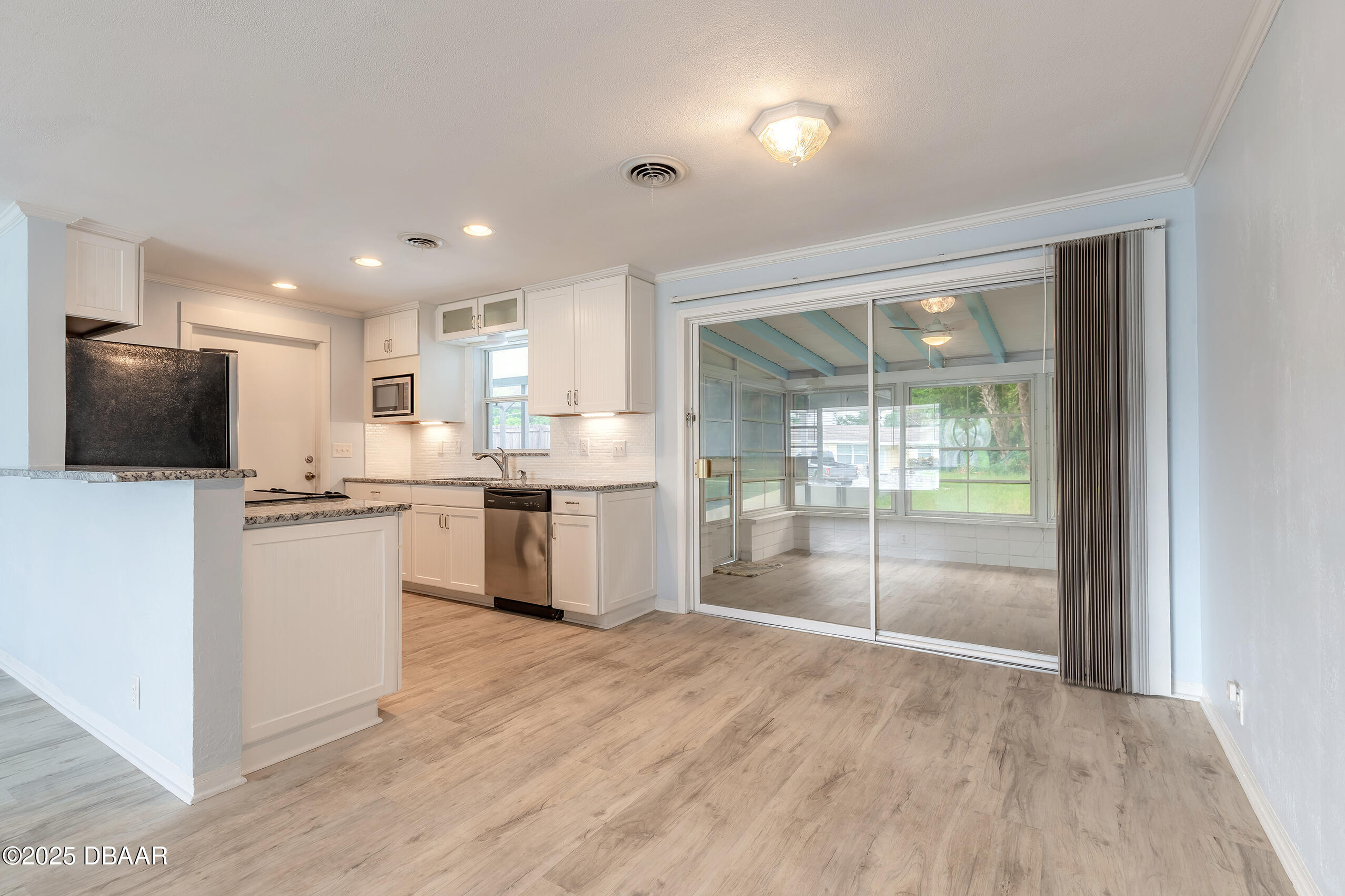 45 Rivocean Drive Ormond Beach, FL 32176 - Photo 14 of 37 a kitchen with white cabinets and white appliances