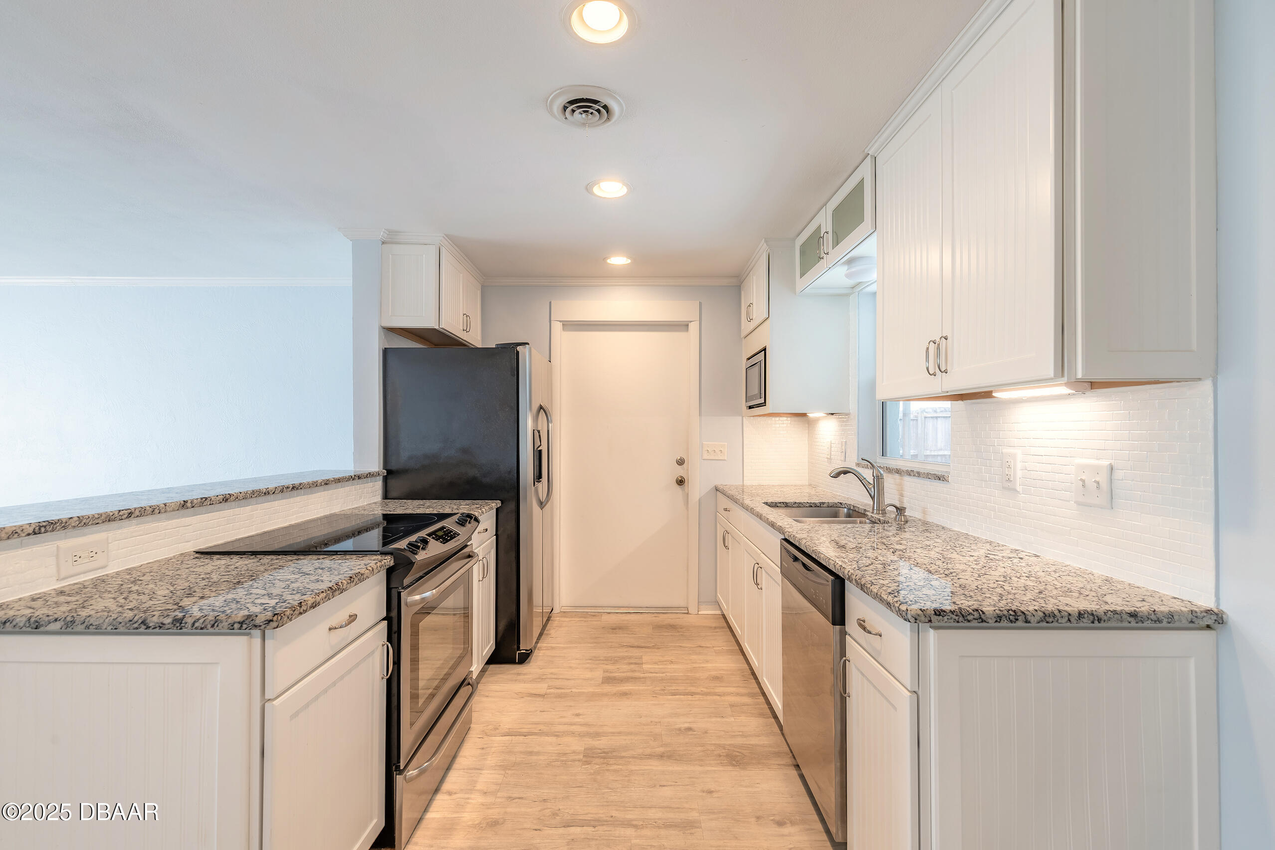 45 Rivocean Drive Ormond Beach, FL 32176 - Photo 16 of 37 a kitchen with stainless steel appliances granite countertop a sink stove and refrigerator