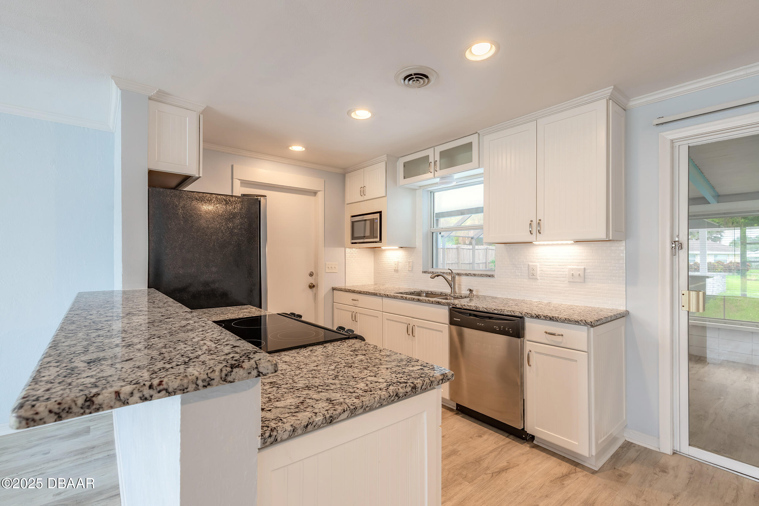 45 Rivocean Drive Ormond Beach, FL 32176 - Photo 17 of 37 a kitchen with granite countertop cabinets stainless steel appliances and a counter space