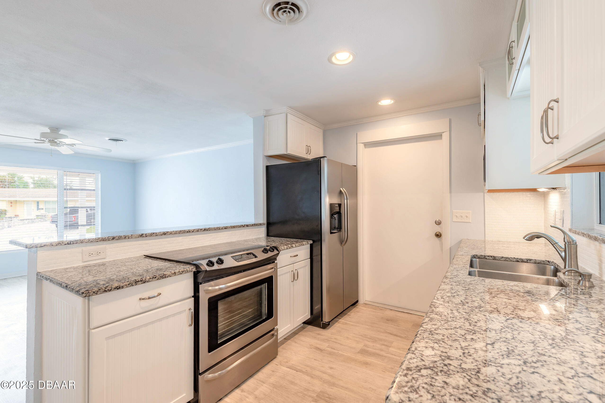 45 Rivocean Drive Ormond Beach, FL 32176 - Photo 18 of 37 a kitchen with granite countertop a stove and a refrigerator