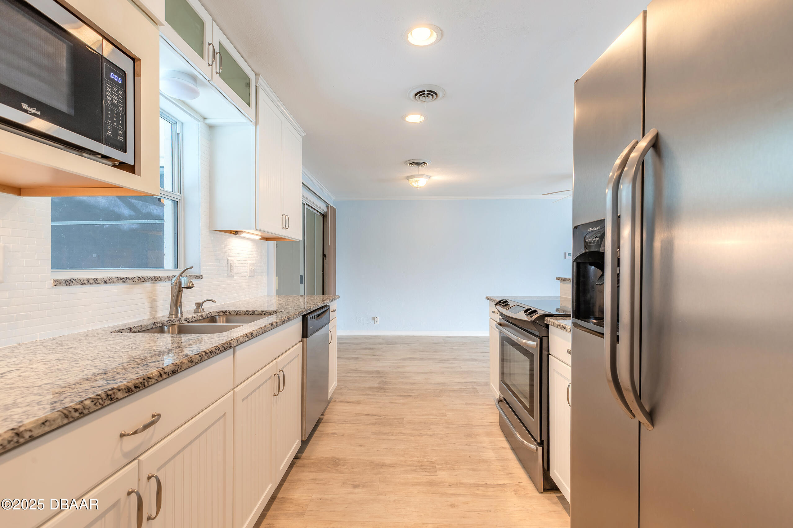 45 Rivocean Drive Ormond Beach, FL 32176 - Photo 19 of 37 a kitchen with granite countertop a refrigerator and a sink