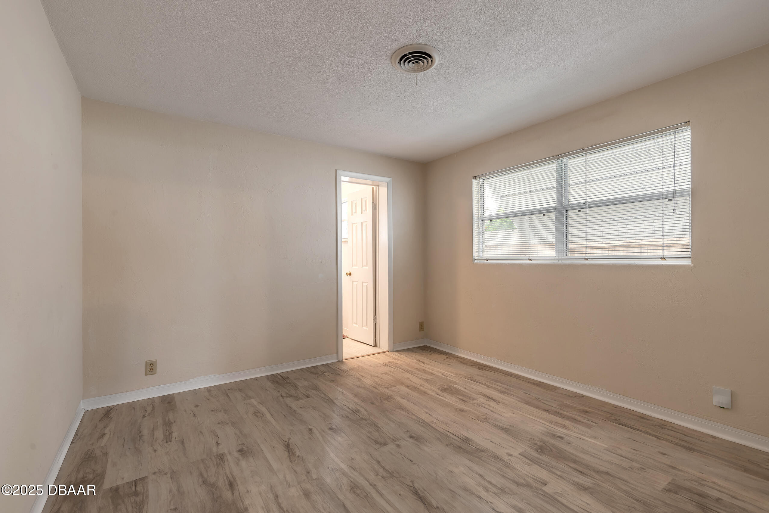 45 Rivocean Drive Ormond Beach, FL 32176 - Photo 7 of 37 an empty room with wooden floor and windows