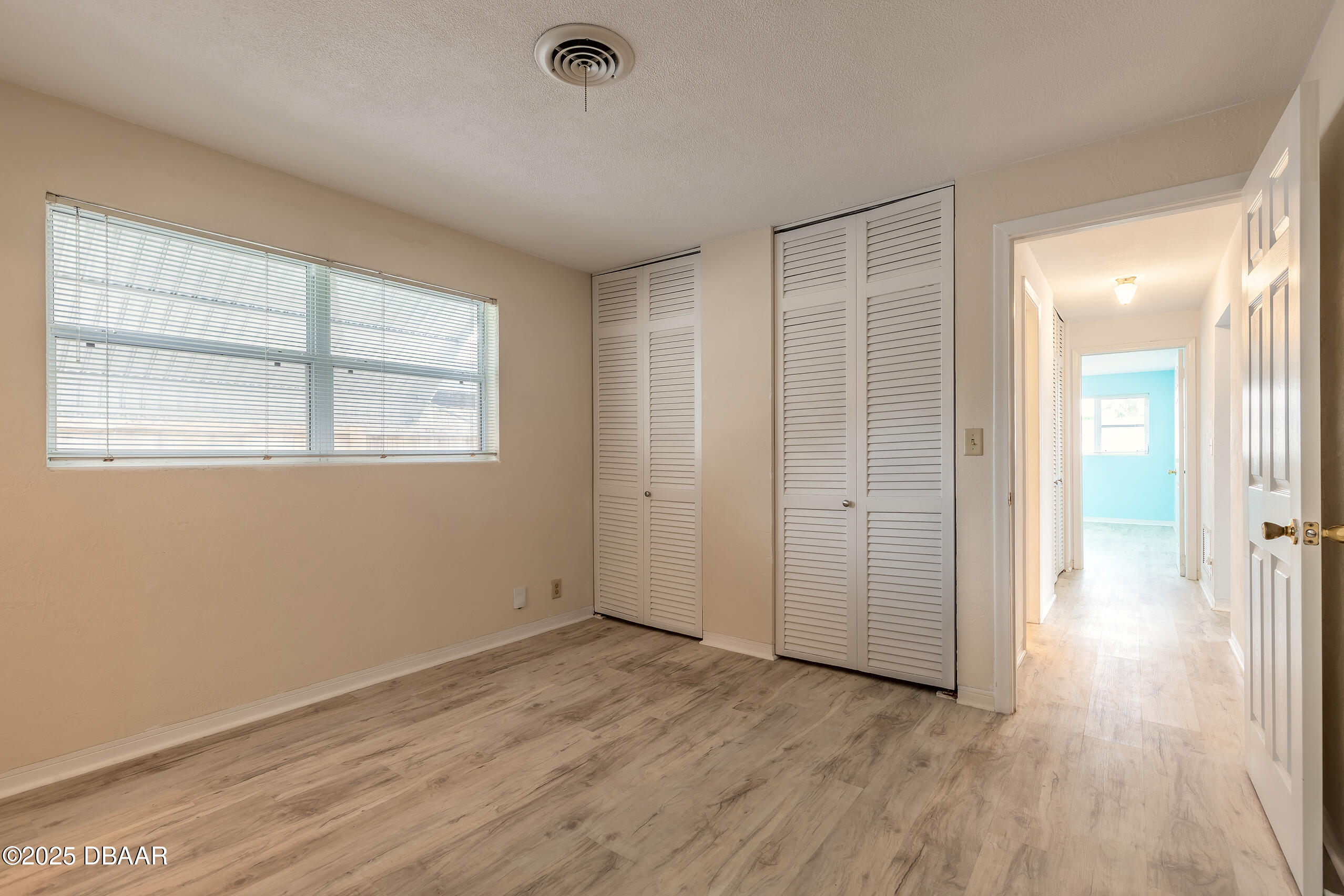 45 Rivocean Drive Ormond Beach, FL 32176 - Photo 8 of 37 an empty room with wooden floor and windows