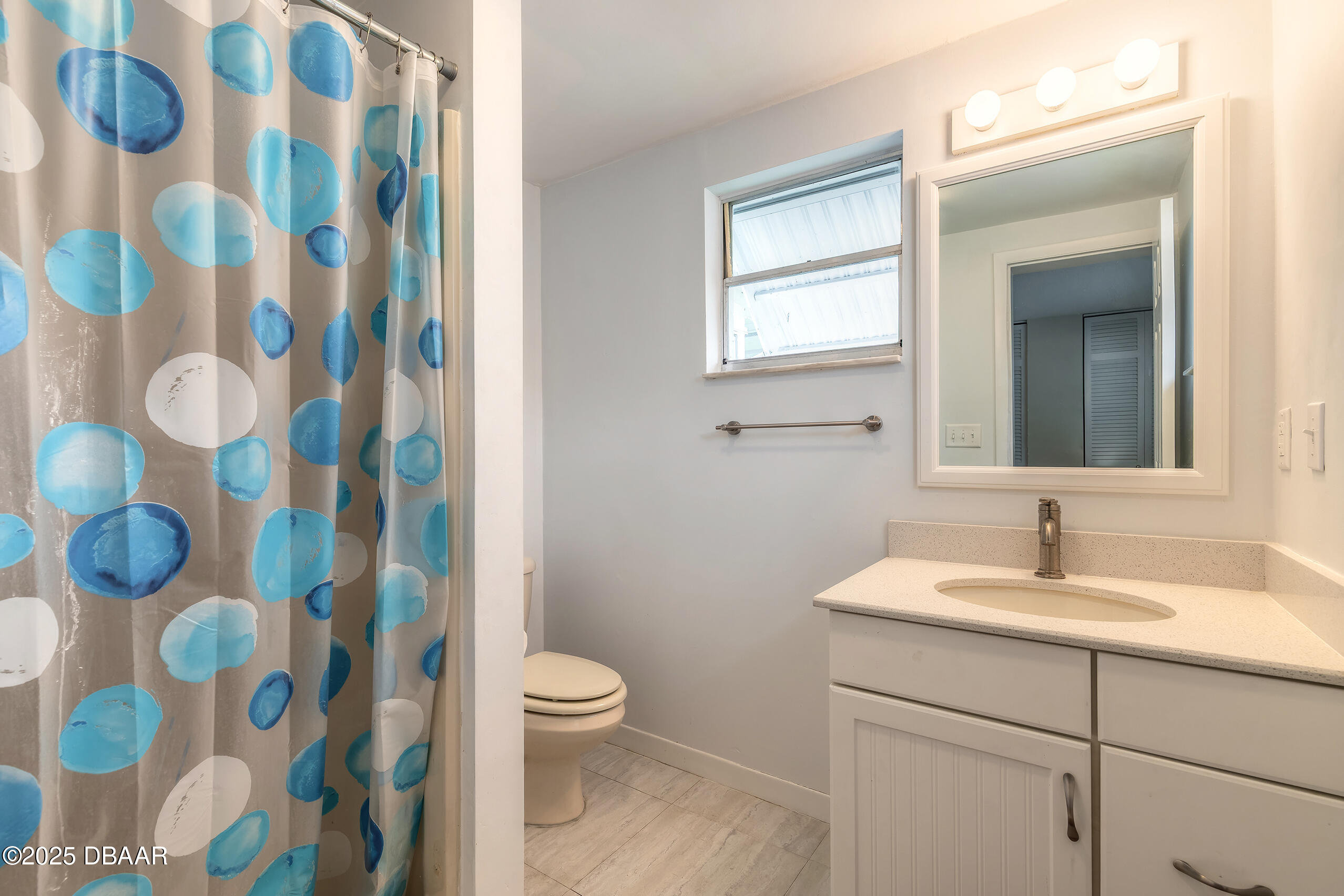 45 Rivocean Drive Ormond Beach, FL 32176 - Photo 9 of 37 a bathroom with a sink and mirror with toilet