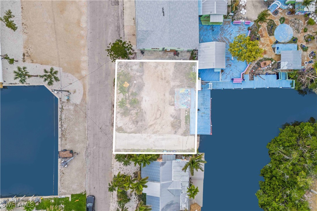 11306 Matlacha Avenue Matlacha, FL 33993 - Photo 2 of 11 an aerial view of residential house with outdoor space and swimming pool