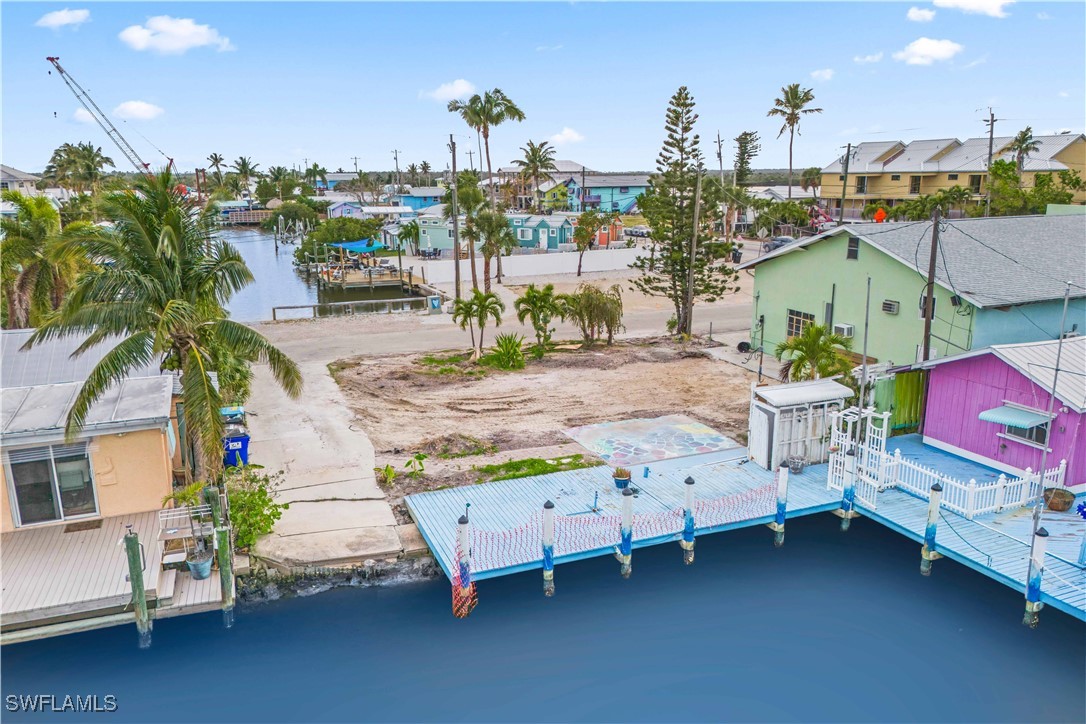 11306 Matlacha Avenue Matlacha, FL 33993 - Photo 4 of 11 a backyard of a house with barbeque oven table and chairs