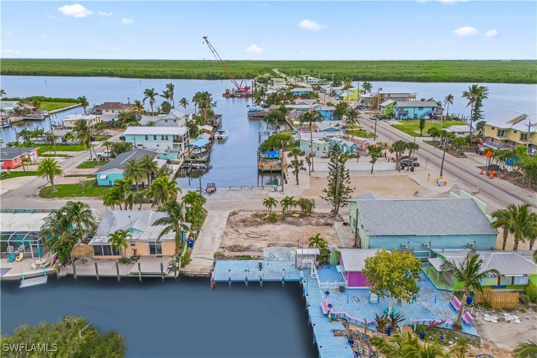11306 Matlacha Avenue Matlacha, FL 33993 - Photo 10 of 11 an aerial view of a house with a garden and lake view