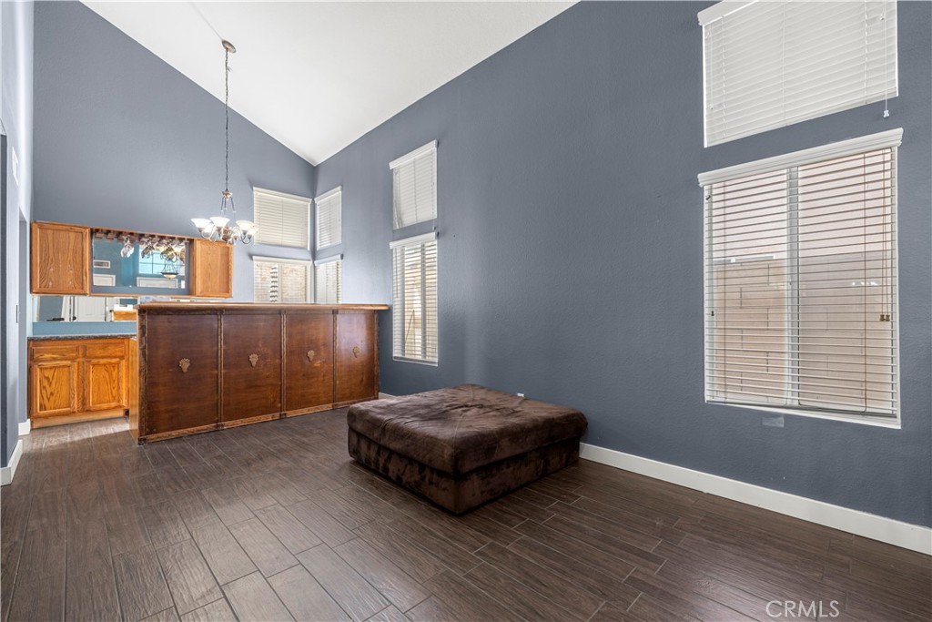 15417 Tobarra Road Fontana, CA 92337 - Photo 5 of 29 a living room with a couch and a dresser next to a window