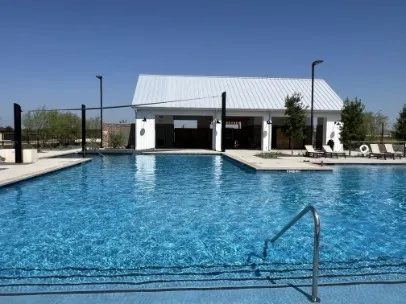 a view of swimming pool with outdoor seating and city view