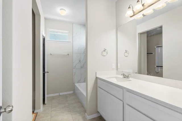 a bathroom with a double vanity sink a mirror and a shower