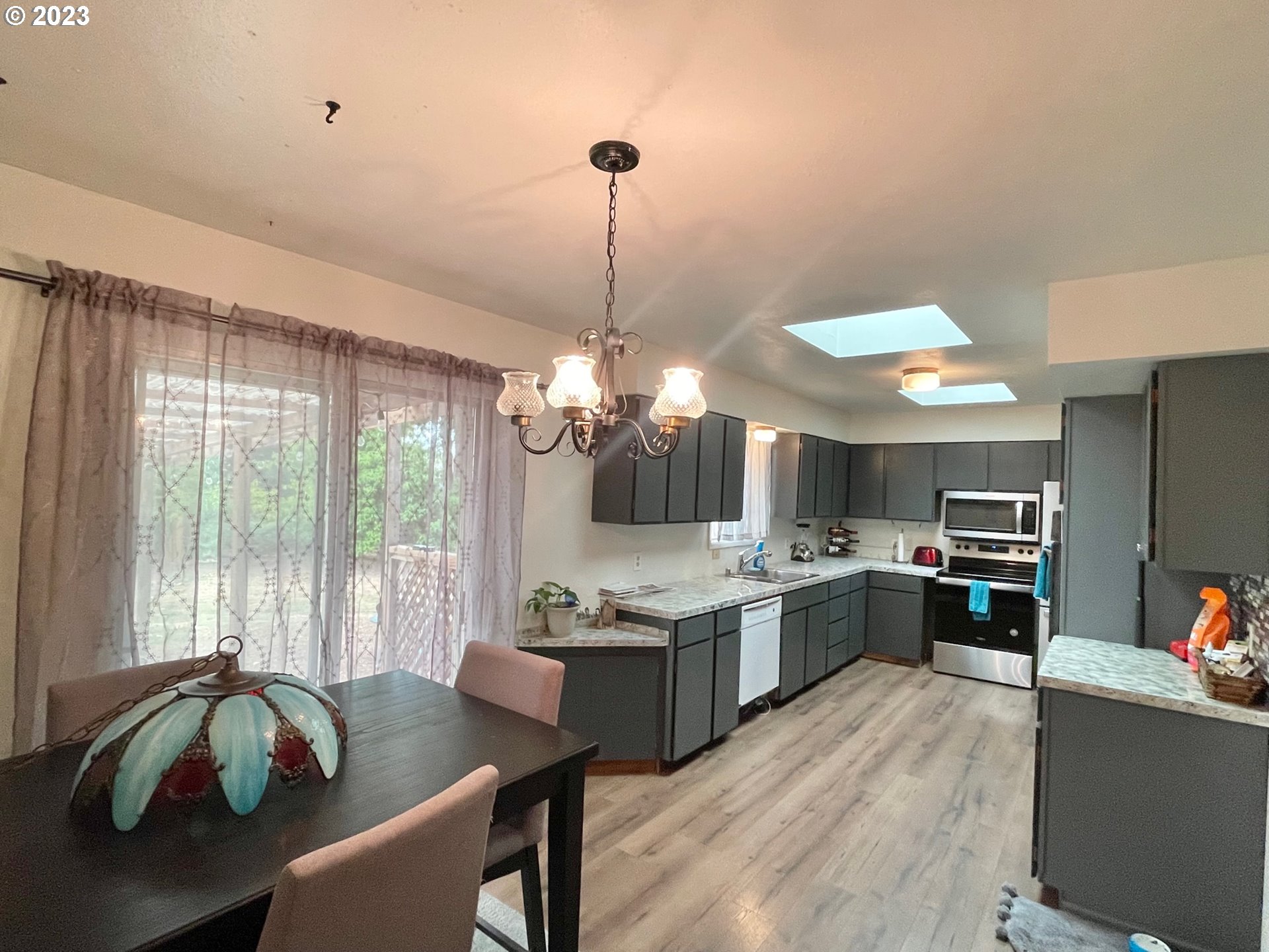 2113 Austin Road Roseburg, OR 97471 - Photo 12 of 36 a kitchen with kitchen island a stove a sink a oven dining table and chairs