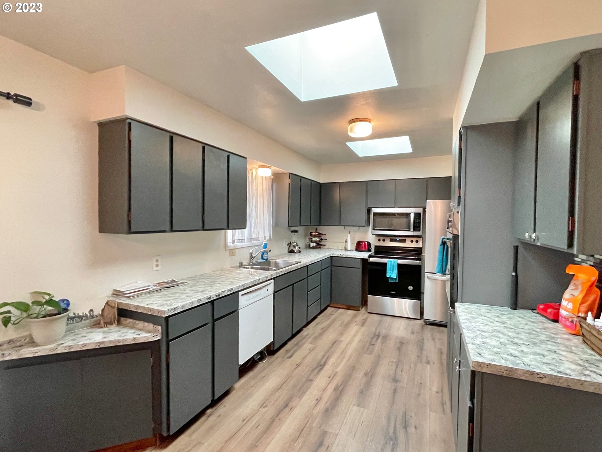 2113 Austin Road Roseburg, OR 97471 - Photo 10 of 36 a large kitchen with a counter space a sink stainless steel appliances and cabinets