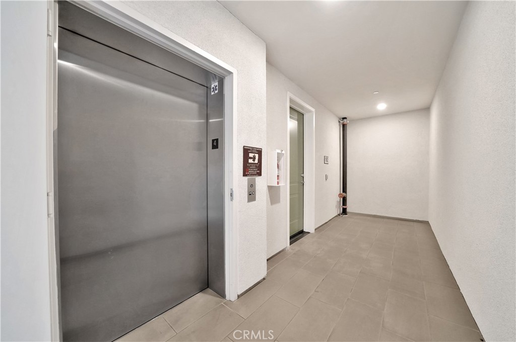 192 Tribeca Irvine, CA 92612 - Photo 29 of 32 a view of a hallway with wooden shelves