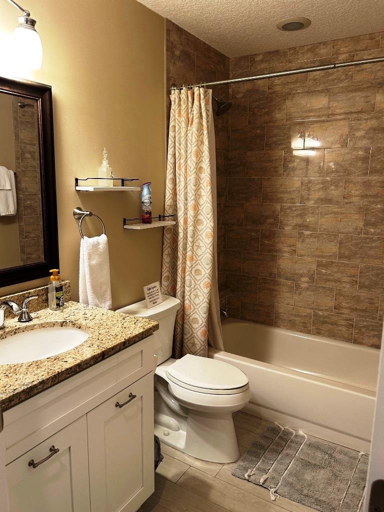 5067 Atlantic View St. Augustine, FL 32080 - Photo 15 of 47 a bathroom with a granite countertop sink toilet and shower