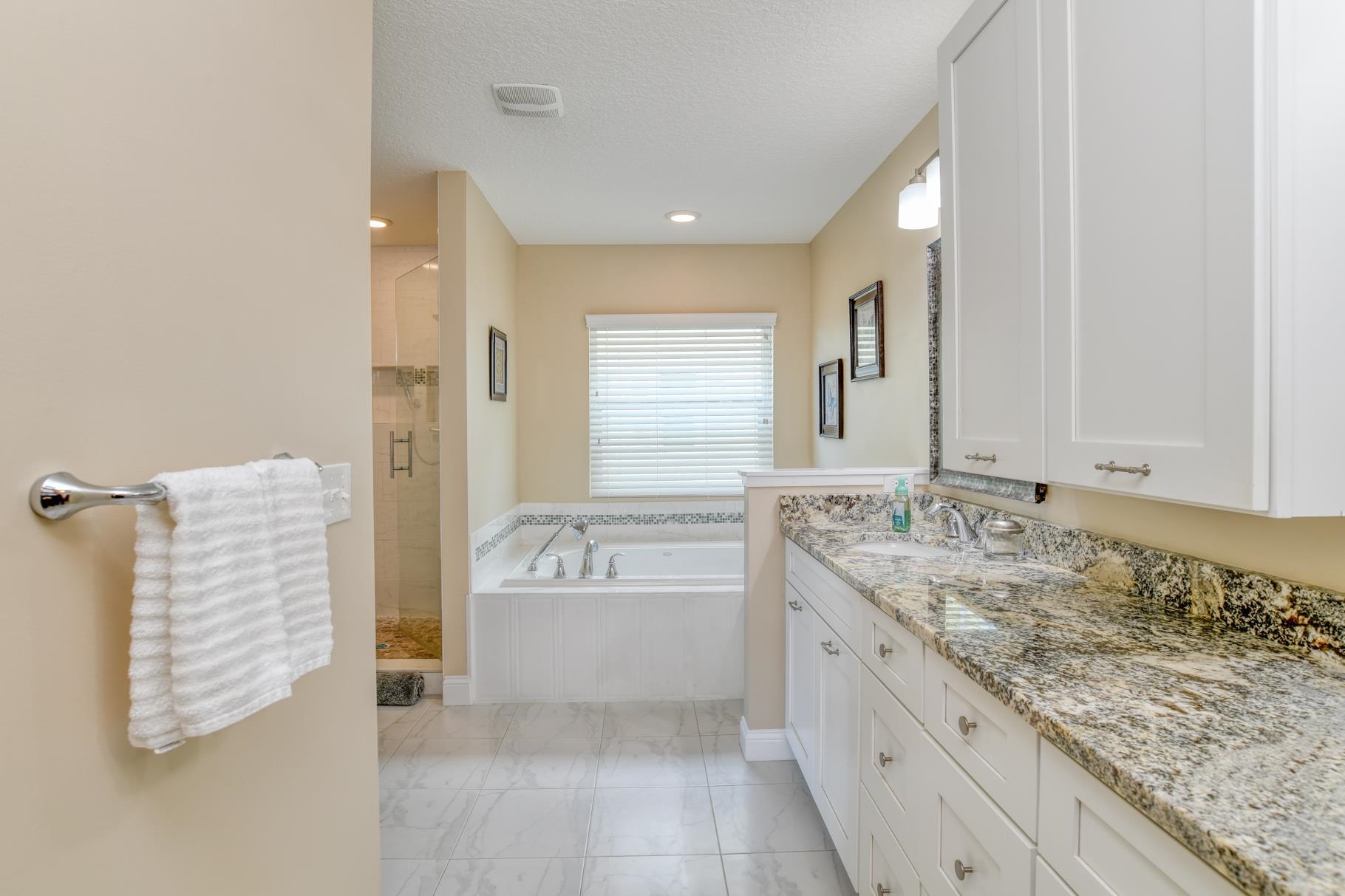 5067 Atlantic View St. Augustine, FL 32080 - Photo 19 of 47 a bathroom with a granite countertop sink and a mirror