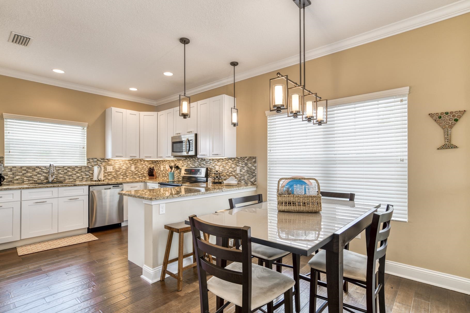 5067 Atlantic View St. Augustine, FL 32080 - Photo 28 of 47 a kitchen with stainless steel appliances granite countertop a dining table chairs and white cabinets