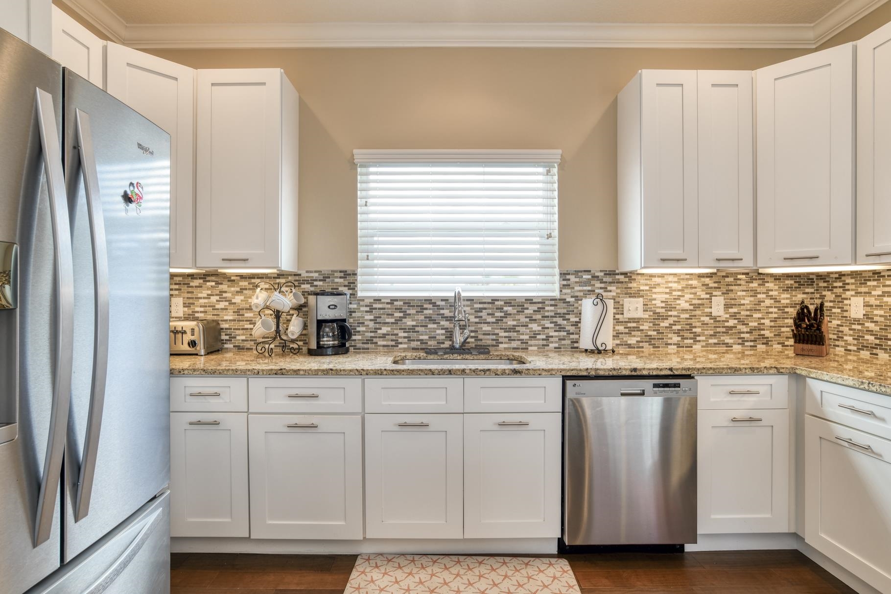 5067 Atlantic View St. Augustine, FL 32080 - Photo 31 of 47 a kitchen with granite countertop a sink and cabinets