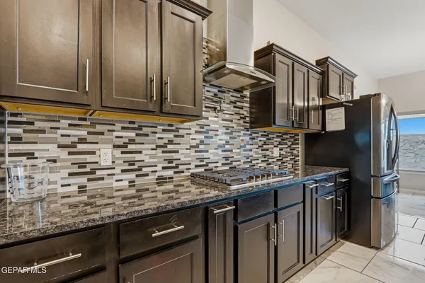 a kitchen with stainless steel appliances granite countertop a sink counter space and cabinets