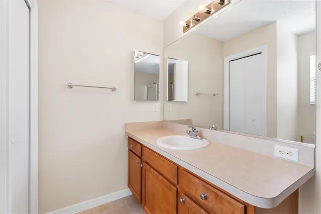 a bathroom with a sink vanity and a mirror