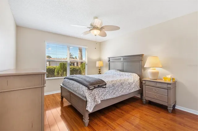 a bedroom with a bed mirror and a window