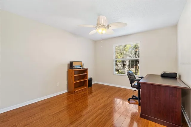 a view of a workspace with furniture and a window