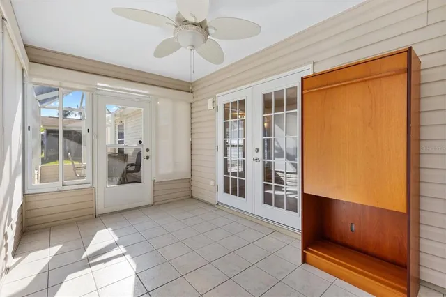 a view of an entryway with wooden cabinet and door
