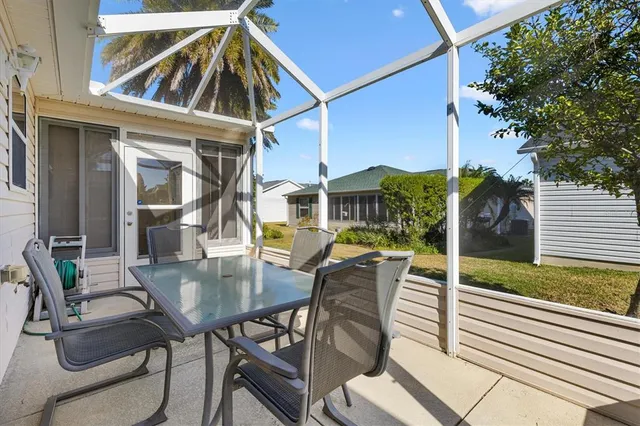 a view of a patio with table and chairs and potted plants