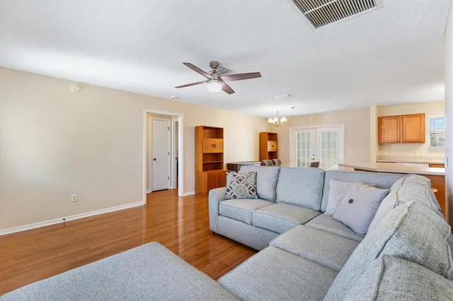 a living room with furniture and a ceiling fan