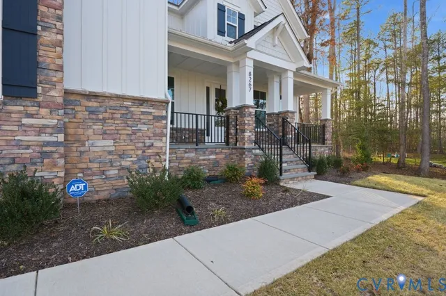 a view of a white house next to a yard