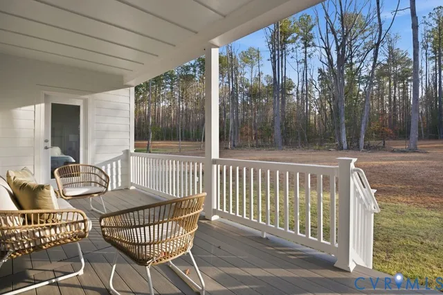 a porch with a bench next to a yard