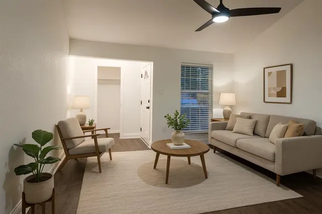 a living room with furniture and a potted plant