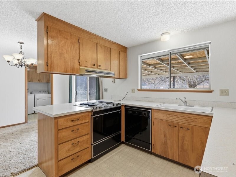 702 West Ridge Drive Omak, WA 98841 - Photo 11 of 26 a kitchen with a stove and a sink