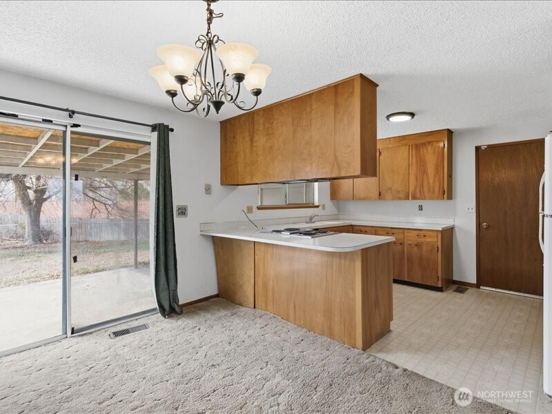 702 West Ridge Drive Omak, WA 98841 - Photo 7 of 26 a kitchen with stainless steel appliances granite countertop a sink stove and refrigerator
