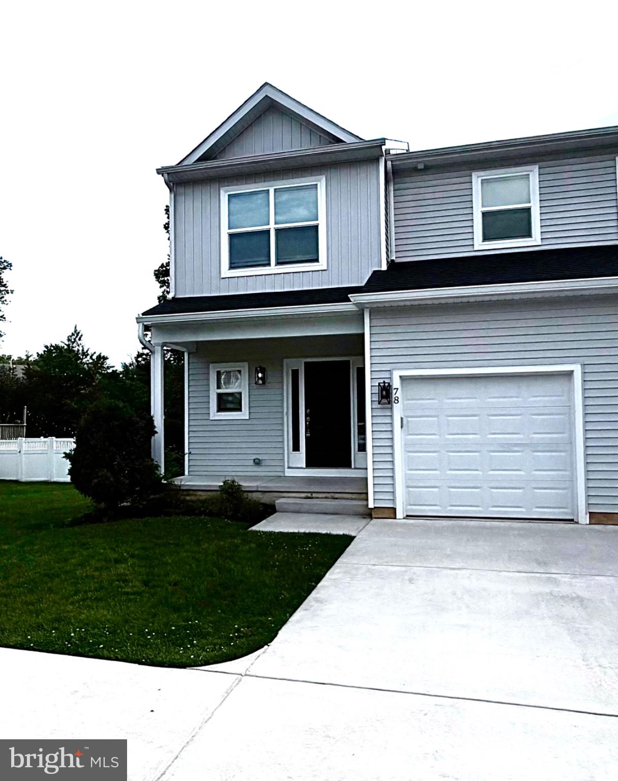 78 Tansboro Road Berlin, NJ 08009 - Photo 20 of 22 a front view of a house with a yard and garage