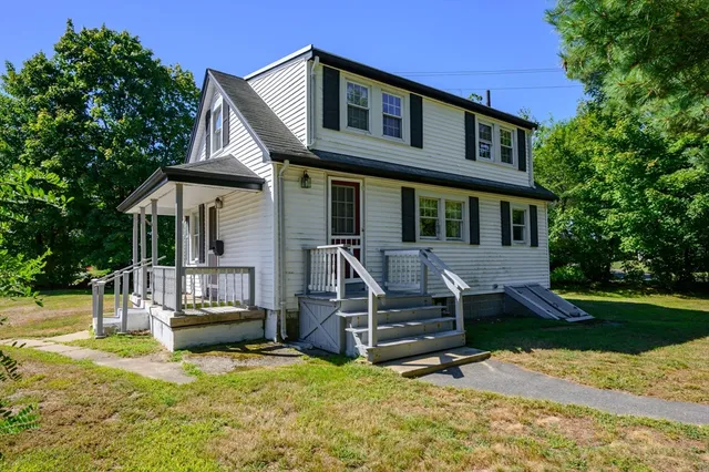 a view of a house with backyard porch and sitting area