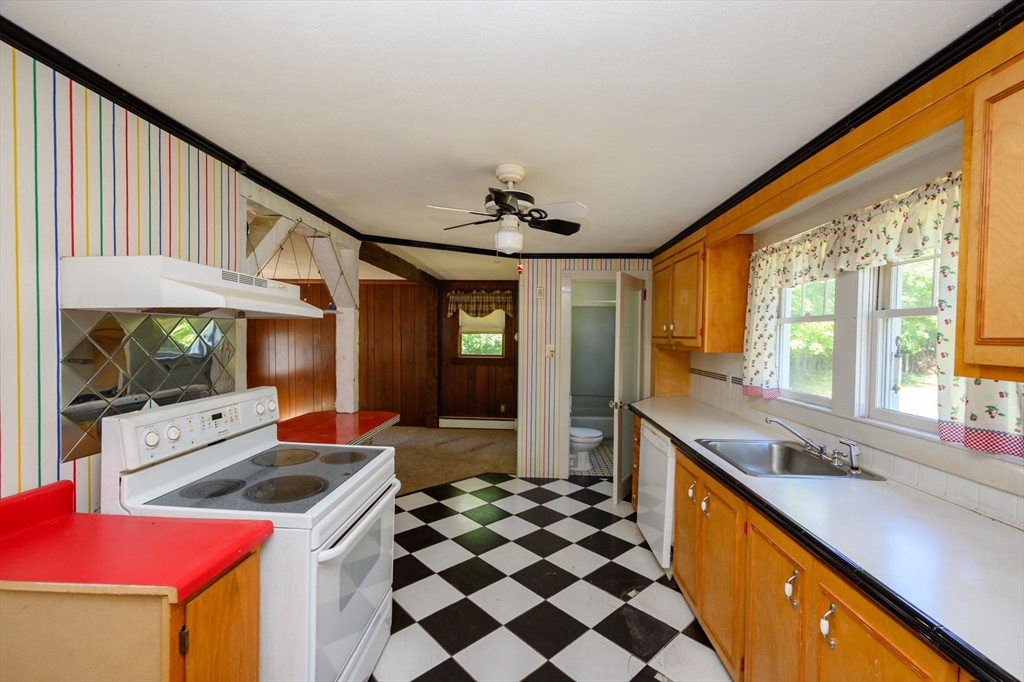 8 Walnut Street Whitman, MA 02382 - Photo 4 of 17 a kitchen with a sink a stove and a refrigerator